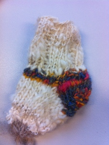 Baby sock made out of home-spun yarn